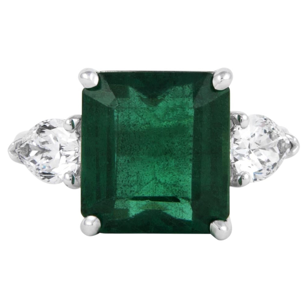 18k White Gold 3-Stone Ring GIA 5.97ct Emerald Diamond: 18k White Gold 3-Stone Ring GIA 5.97ct Emerald Diamond Contemporary 3-stone ring featuring a GIA-certified 5.97 ct emerald-cut emerald and two GIA-certified pear brilliant diamonds totaling 1.12 ct. C