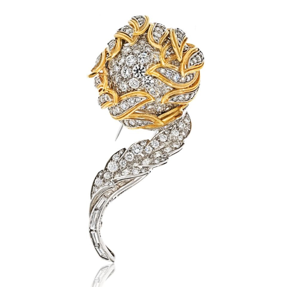 Vintage Diamond Flower Bud Brooch in Platinum and 18K Yellow Gold: Vintage Diamond Flower Bud Brooch in Platinum and 18K Yellow Gold Estate brooch from the 1970s featuring a diamond flower design crafted in platinum and 18K yellow gold. The piece showcases a flower b