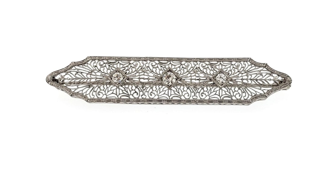 Art Deco diamond brooch platinum with 14k white gold filigree pin: Art Deco diamond brooch platinum with 14k white gold filigree pin This exquisite Art Deco brooch showcases a stunning combination of platinum and 14k white gold. Designed with a long frame, it feature