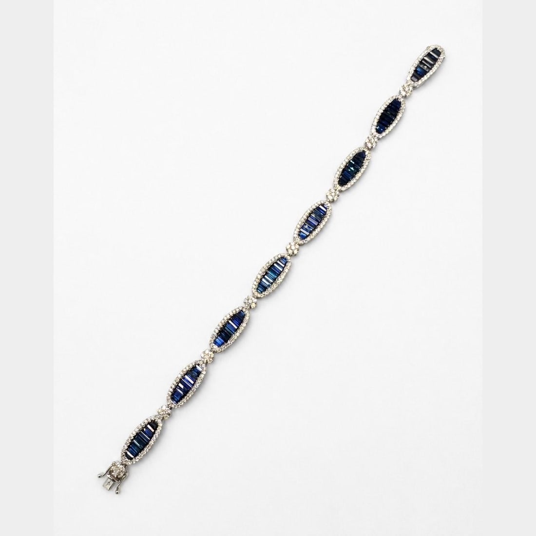 7 Inch 18K White Gold Bracelet with Sapphires and 2.28 Ct Diamonds: 7 Inch 18K White Gold Bracelet with Sapphires and 2.28 Ct Diamonds Pre-owned bracelet crafted in 18K white gold and set with sapphires and diamonds. The piece features a substantial design with stampe
