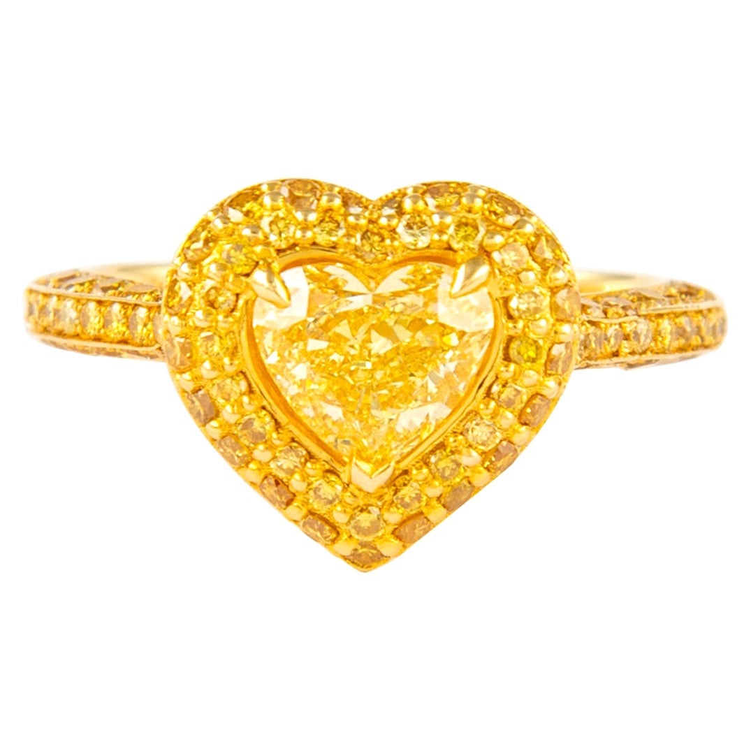 1.92ct Fancy Intense Yellow Heart Diamond Ring 18k GIA Certified: 1.92ct Fancy Intense Yellow Heart Diamond Ring 18k GIA Certified This exquisite GIA certified Fancy Intense Yellow Heart Diamond Ring features a stunning heart cut diamond weighing 0.90 carats, graded