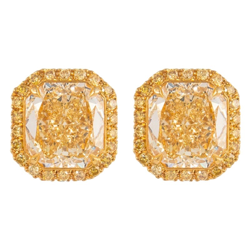 18k Gold GIA 9.05ct Yellow Diamond Stud Earrings: 18k Gold GIA 9.05ct Yellow Diamond Stud Earrings Pair of contemporary stud earrings featuring two GIA-certified radiant-cut Fancy Intense Yellow diamonds accented by a yellow diamond halo and pave-set