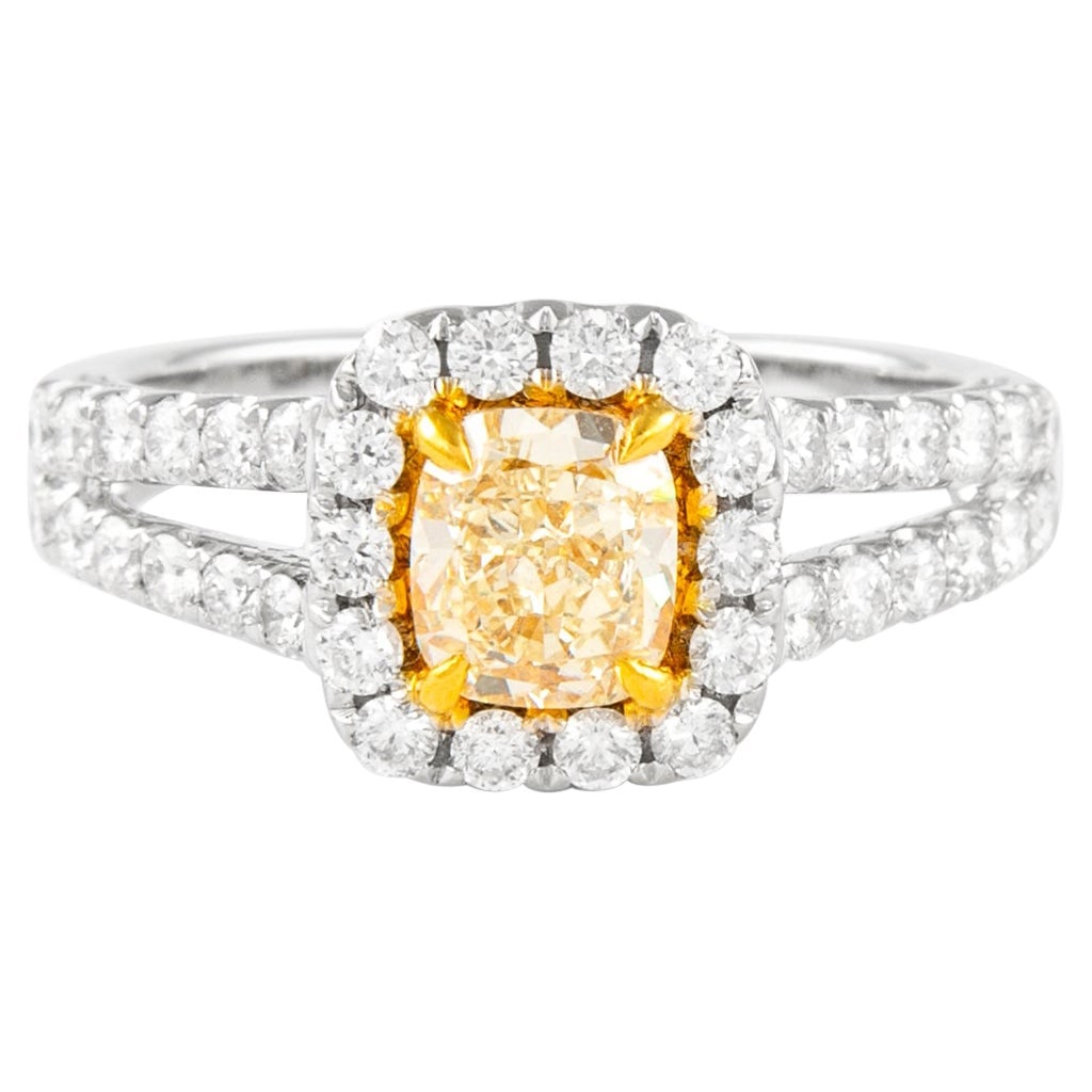 18k Two Tone Gold Fancy Yellow Diamond Halo Ring: 18k Two Tone Gold Fancy Yellow Diamond Halo Ring Contemporary 18k two-tone white and yellow gold ring featuring a Fancy Yellow cushion cut diamond center with a diamond halo and split shank design. Th
