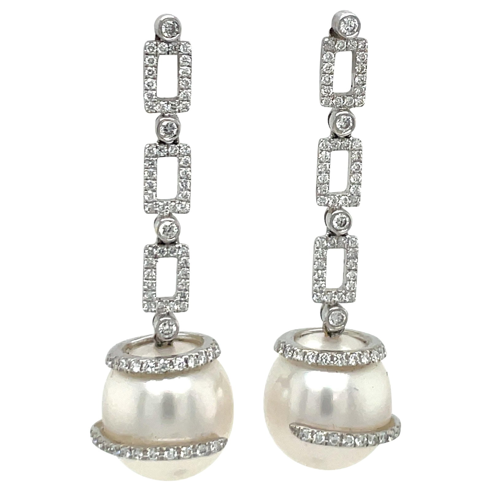 South Sea Pearl Drop Earrings in 18k White Gold with 1.14 Carat Diamonds: South Sea Pearl Drop Earrings in 18k White Gold with 1.14 Carat Diamonds Contemporary drop earrings crafted in 18 karat white gold, featuring round brilliant diamonds and South Sea pearls in a geometr