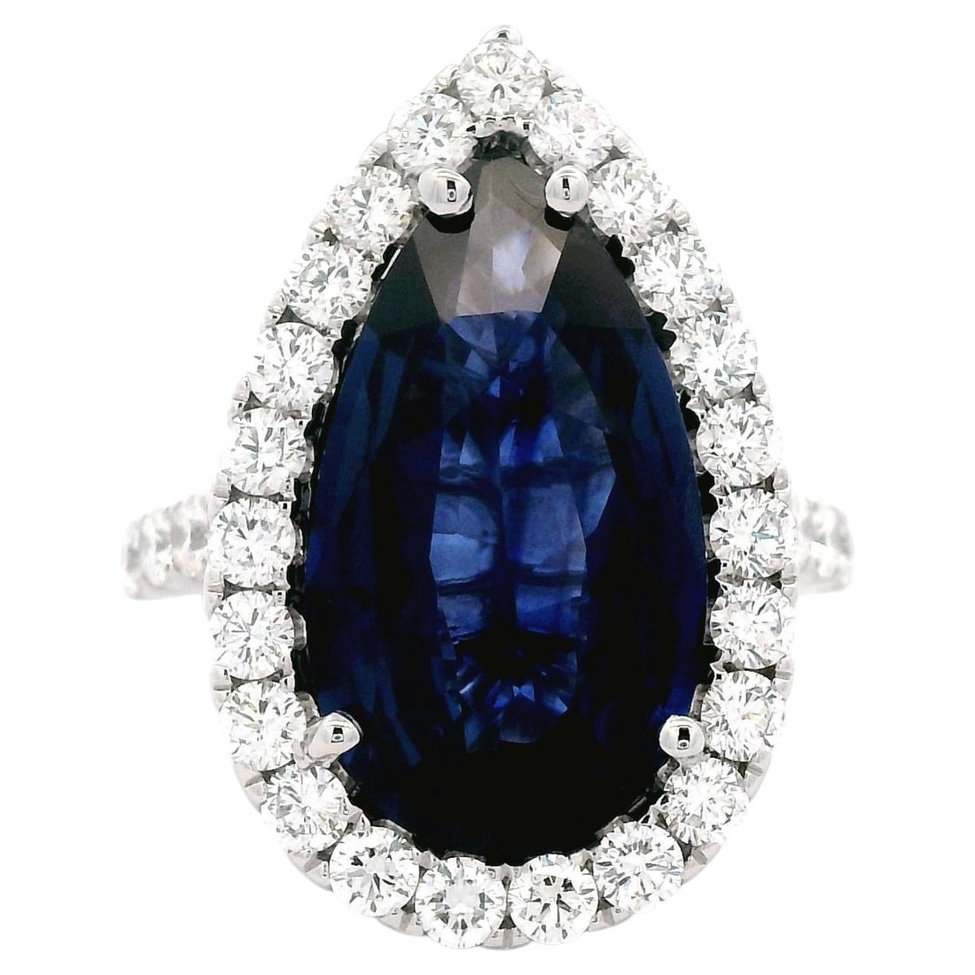 18k White Gold Ring GIA 7.76ct Ceylon Sapphire Diamond: 18k White Gold Ring GIA 7.76ct Ceylon Sapphire Diamond GIA-certified ring featuring a 7.76 ct pear shape Ceylon blue sapphire surrounded by a diamond halo. The ring is set with 33 round brilliant diam