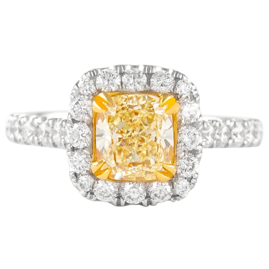 Fancy Yellow VS1 Cushion Diamond Halo Ring 18k Gold: Fancy Yellow VS1 Cushion Diamond Halo Ring 18k Gold Contemporary cushion-cut fancy yellow diamond halo ring in two-tone 18k white and yellow gold. The ring features a 1.27 ct EGL-graded Fancy Yellow V