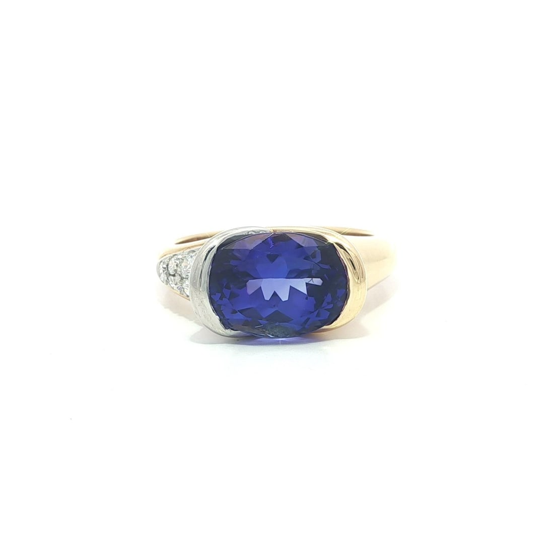 Krementz 18k Yellow Gold Tanzanite Diamond Cocktail Ring 3.66ctw: Krementz 18k Yellow Gold Tanzanite Diamond Cocktail Ring 3.66ctw This stunning cocktail ring features a captivating natural oval tanzanite, channel set for a secure fit. The tanzanite showcases a beau