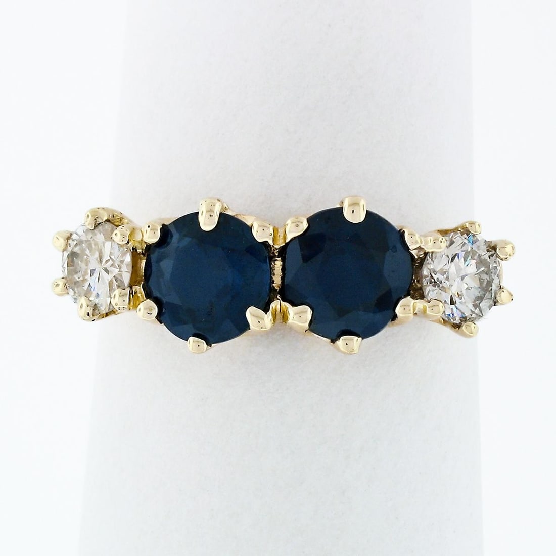 Sapphire and Diamond Band Ring in 17-18k Yellow Gold 2.16ctw: Sapphire and Diamond Band Ring in 17-18k Yellow Gold 2.16ctw Vintage band ring featuring two natural round blue sapphires and two round brilliant diamonds in a six-prong setting. Crafted in solid 17-1