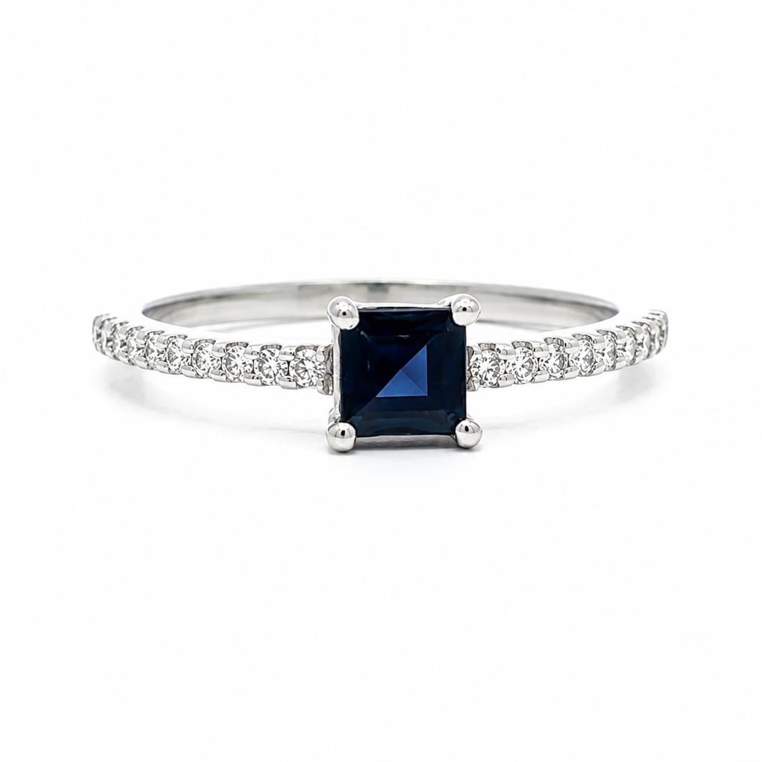 14k White Gold Ring with Square Sapphire and Diamond Accents: 14k White Gold Ring with Square Sapphire and Diamond Accents Pre-owned dainty band ring crafted in solid 14k white gold, featuring a natural blue square step cut sapphire accented by natural diamond s
