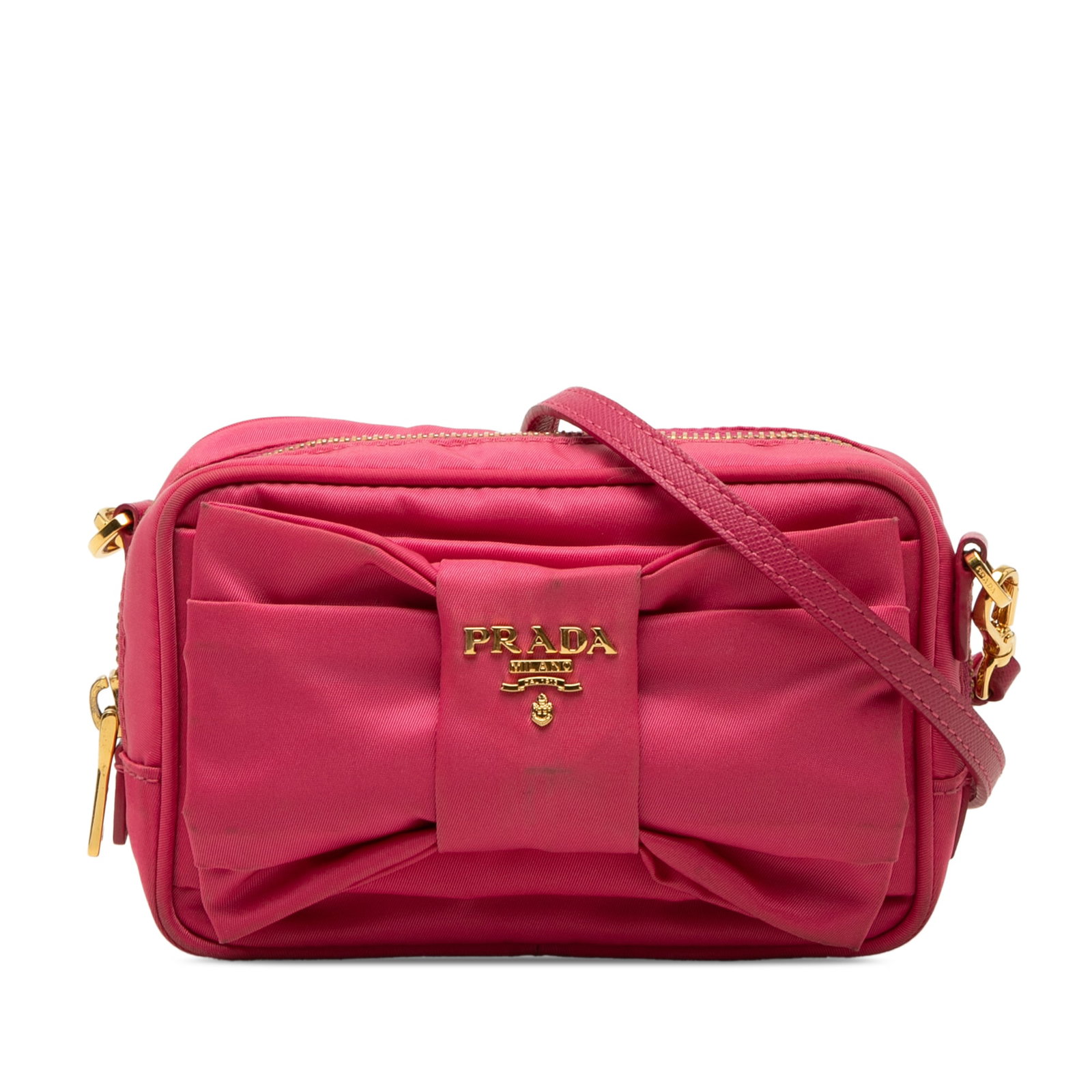Prada Tessuto Fiocco crossbody camera bag in pink nylon: Prada Tessuto Fiocco crossbody camera bag in pink nylon Prada Tessuto Fiocco Bow Camera Bag in pink with a nylon body and signature bow detail. This crossbody style features a detachable and adjustabl