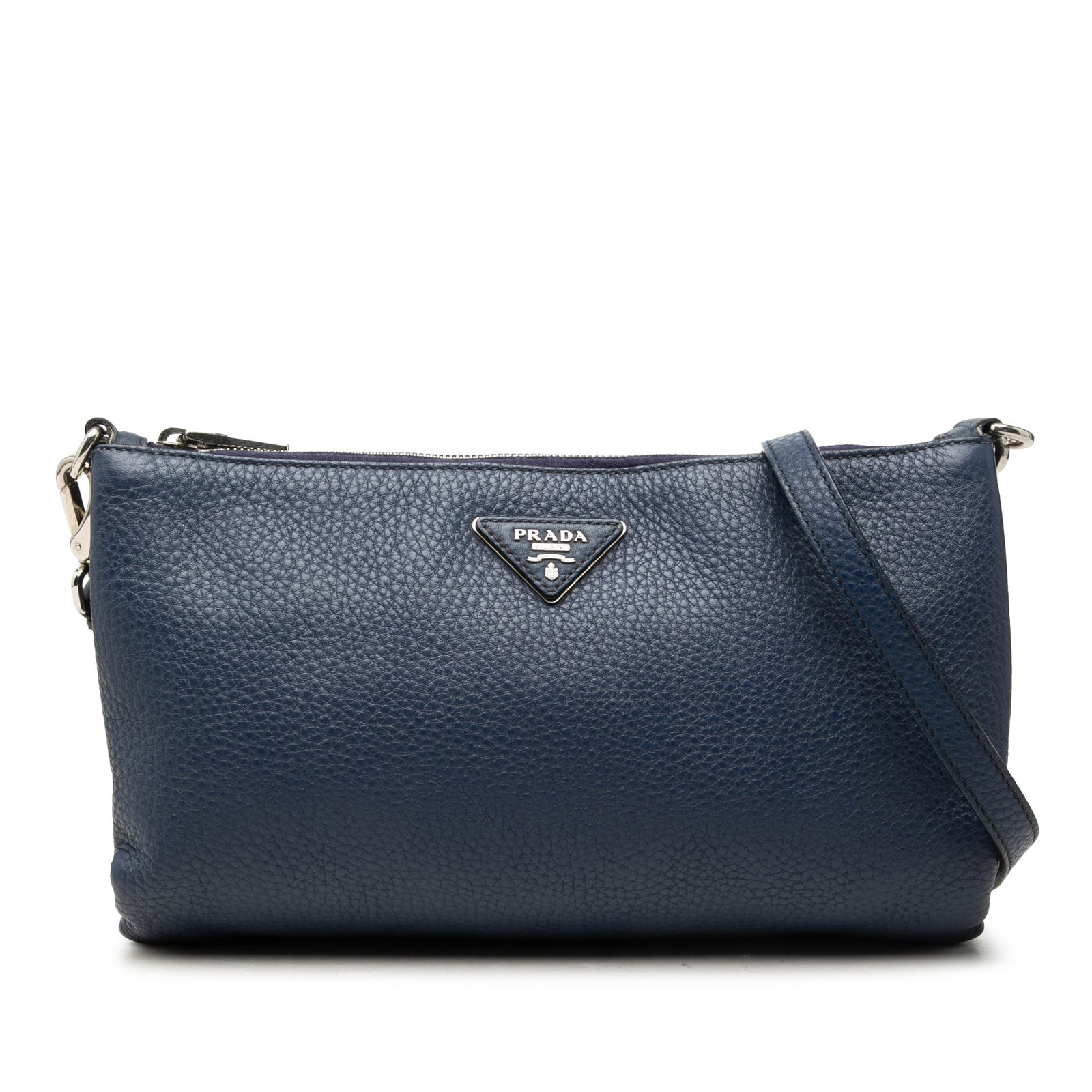 Prada Vitello Daino leather crossbody bag in blue: Prada Vitello Daino leather crossbody bag in blue Prada Vitello Daino crossbody bag in blue leather with a zip-top closure, adjustable detachable flat leather strap, and interior zip and slip pockets.