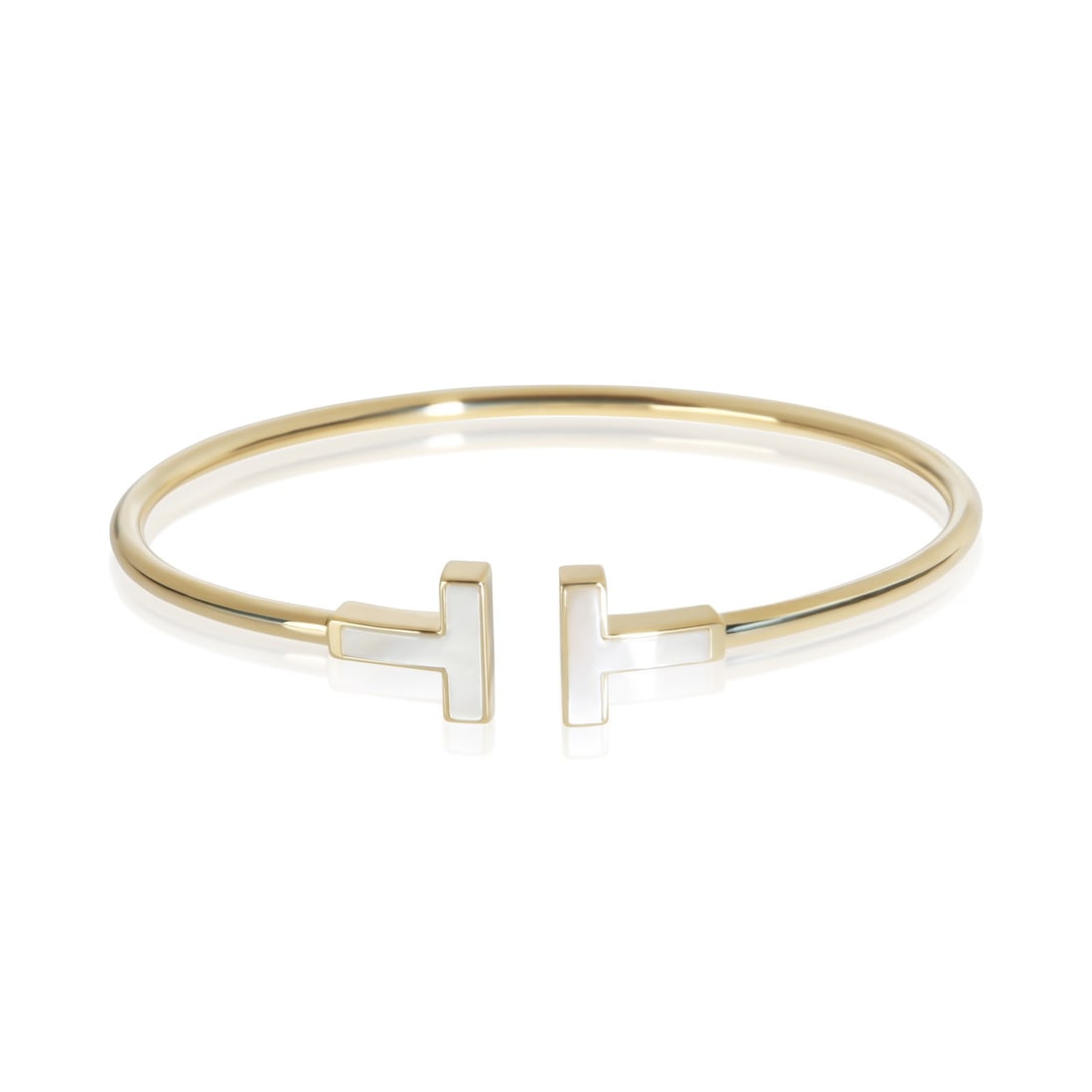 Tiffany & Co. Tiffany T Wire Bracelet 18k Yellow Gold Mother of Pearl: Tiffany & Co. Tiffany T Wire Bracelet 18k Yellow Gold Mother of Pearl Elegant Tiffany T Wire bracelet crafted in 18k yellow gold and accented with mother of pearl. This women's bracelet from the Tiffa