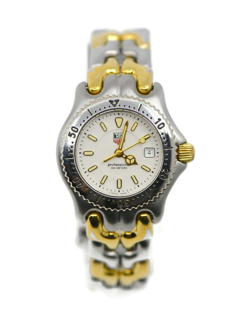 TAG Heuer SEL WG1322 Women's Quartz Wristwatch Two Tone Steel: TAG Heuer SEL WG1322 Women's Quartz Wristwatch Two Tone Steel TAG Heuer SEL women's wristwatch with a two-tone stainless steel design and a white dial. This pre-owned watch features a quartz movement 