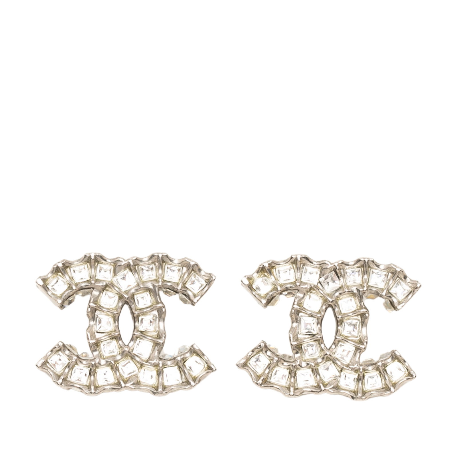 Chanel CC Strass Brass Clip On Earrings: Chanel CC Strass Brass Clip On Earrings Chanel CC push back earrings crafted with a brass metal body and strass detailing. Made in Italy, this costume jewelry pair comes with a dust bag and box. Condi