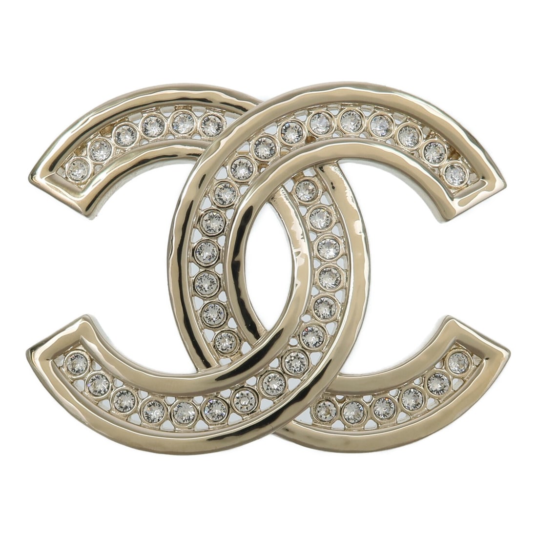 CHANEL CC Gold Tone Metal Brooch with Box: CHANEL CC Gold Tone Metal Brooch with Box CHANEL CC brooch in gold-tone metal with clear accents and a light gold finish. Designed for women and presented with a storage box. Condition is AB: Very Goo