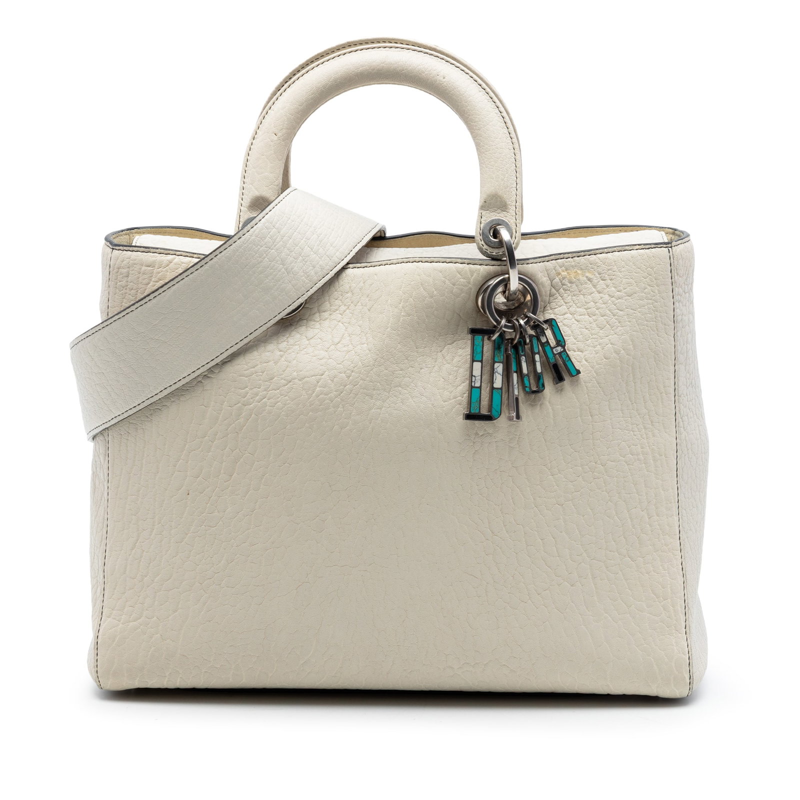 Dior Lady Dior Large grained lambskin handbag white: Dior Lady Dior Large grained lambskin handbag white A Large Canyon Lady Dior handbag crafted in grained lambskin leather with flat handles and a detachable flat leather strap. The design includes a fo
