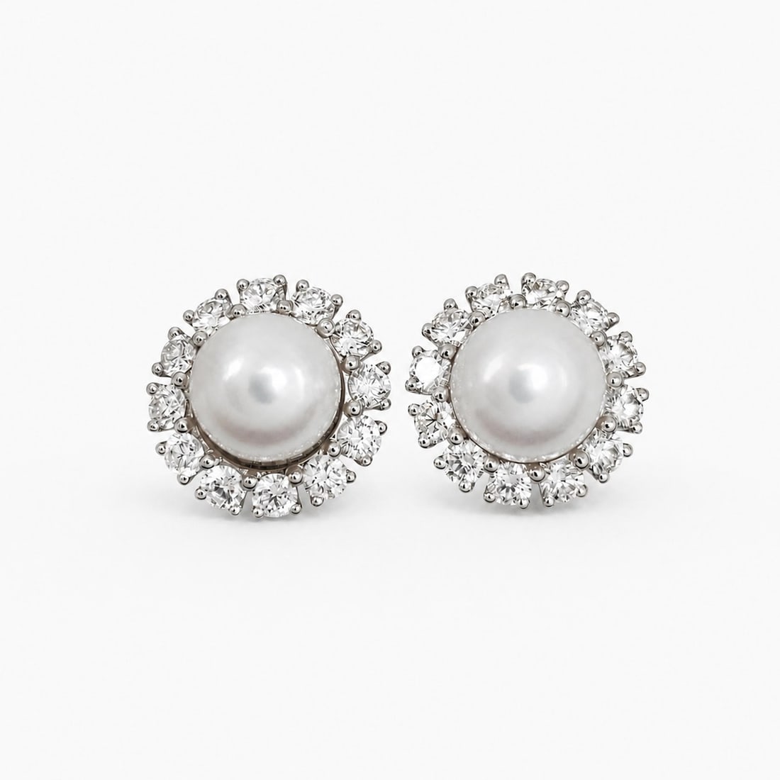 Assael South Sea Pearl Diamond Stud Earrings in 18K White Gold: Assael South Sea Pearl Diamond Stud Earrings in 18K White Gold Elegant Assael stud earrings crafted in 18k white gold, featuring South Sea cultured white pearls framed by halos of round brilliant-cut 