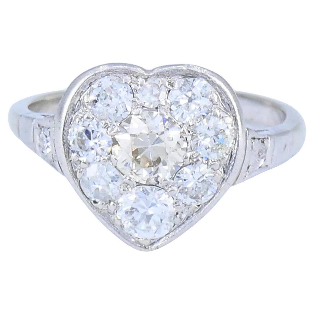 1930s Art Deco heart cluster ring in 10k white gold platinum: 1930s Art Deco heart cluster ring in 10k white gold platinum Vintage Art Deco diamond heart cluster ring from the 1930s, featuring a 10k white gold band with a platinum diamond setting. The design pre