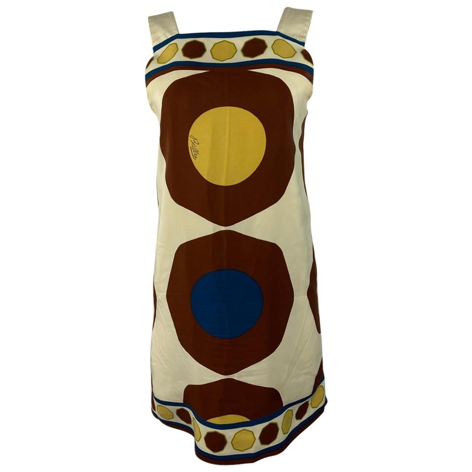 Bally Geometric Print Silk Mini Dress Ivory Sleeveless US 6: Bally Geometric Print Silk Mini Dress Ivory Sleeveless US 6 Vintage Bally sleeveless mini dress in silk with an ivory/cream base and brown, yellow, blue, and green geometric print. It features strap d