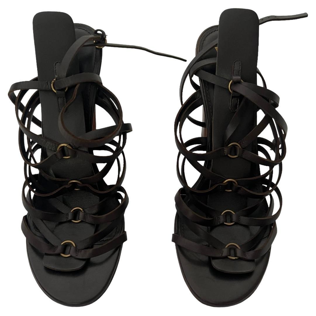 Yves Saint Laurent Rive Gauche T Strap Leather Sandals EU 41: Yves Saint Laurent Rive Gauche T Strap Leather Sandals EU 41 Yves Saint Laurent Rive Gauche brown leather sandals in marked size 41 (EU), featuring round toes, a T-strap, wrap-around design, buckle cl