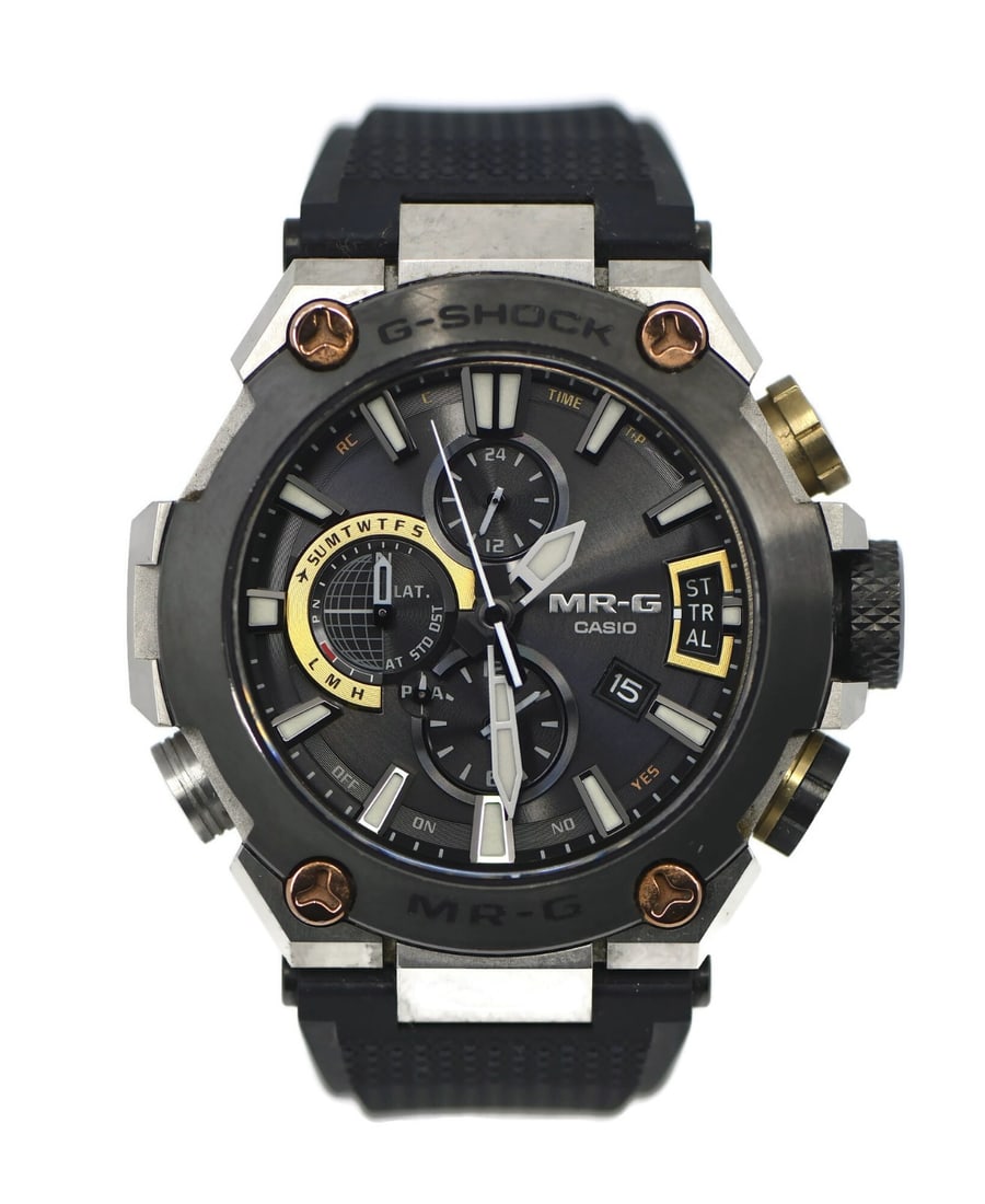 Casio MRG-G2000 men's titanium quartz wristwatch with box: Casio MRG-G2000 men's titanium quartz wristwatch with box Pre-owned Casio MRG-G2000 men's wristwatch with a two-tone titanium case, black analog dial, and quartz movement. This Japan-made watch featur