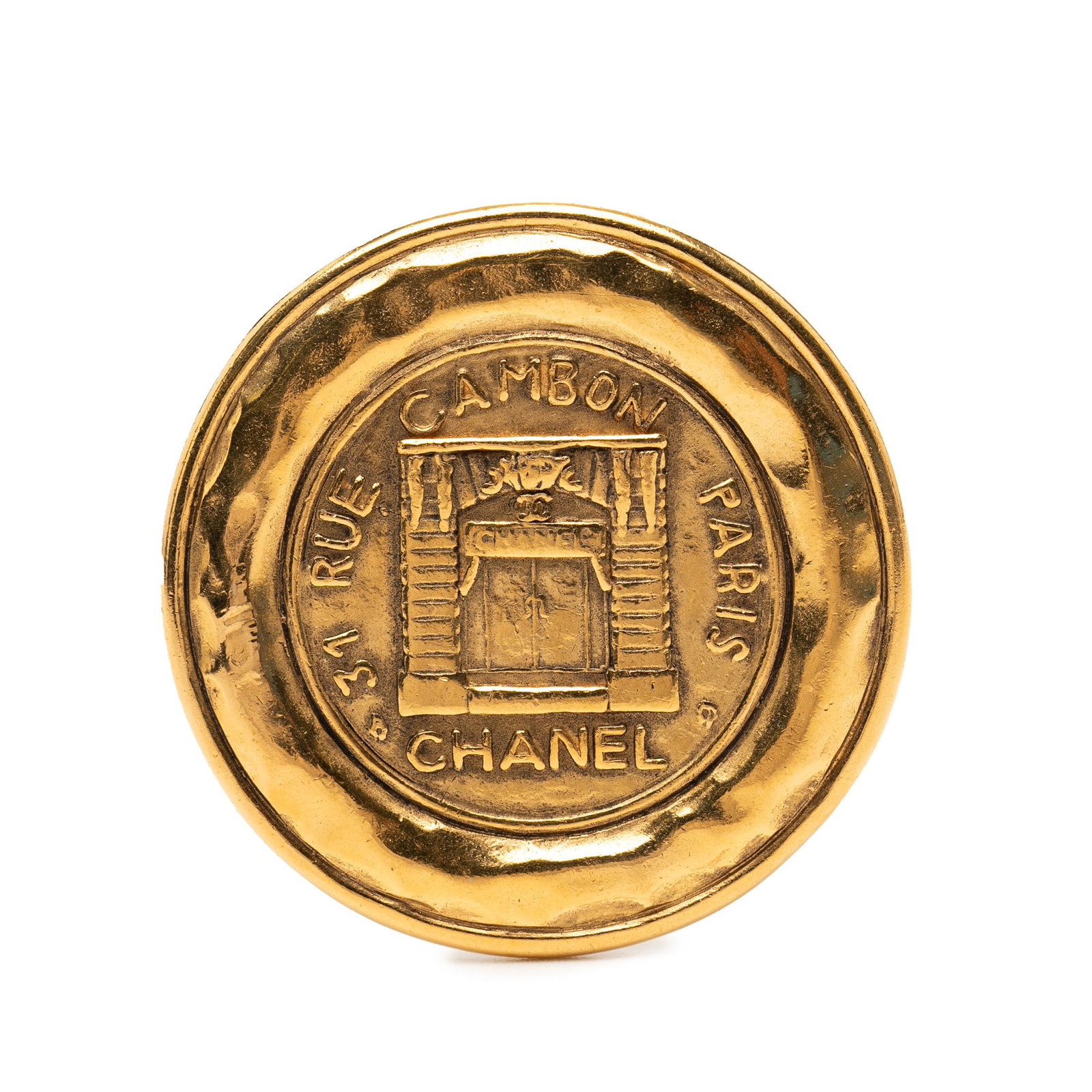 Chanel 31 Rue Cambon Gold Plated Round Brooch: Chanel 31 Rue Cambon Gold Plated Round Brooch This Chanel brooch features a round design crafted from gold-tone metal with a back pin closure. Made in France, it is part of Chanel's costume jewelry co
