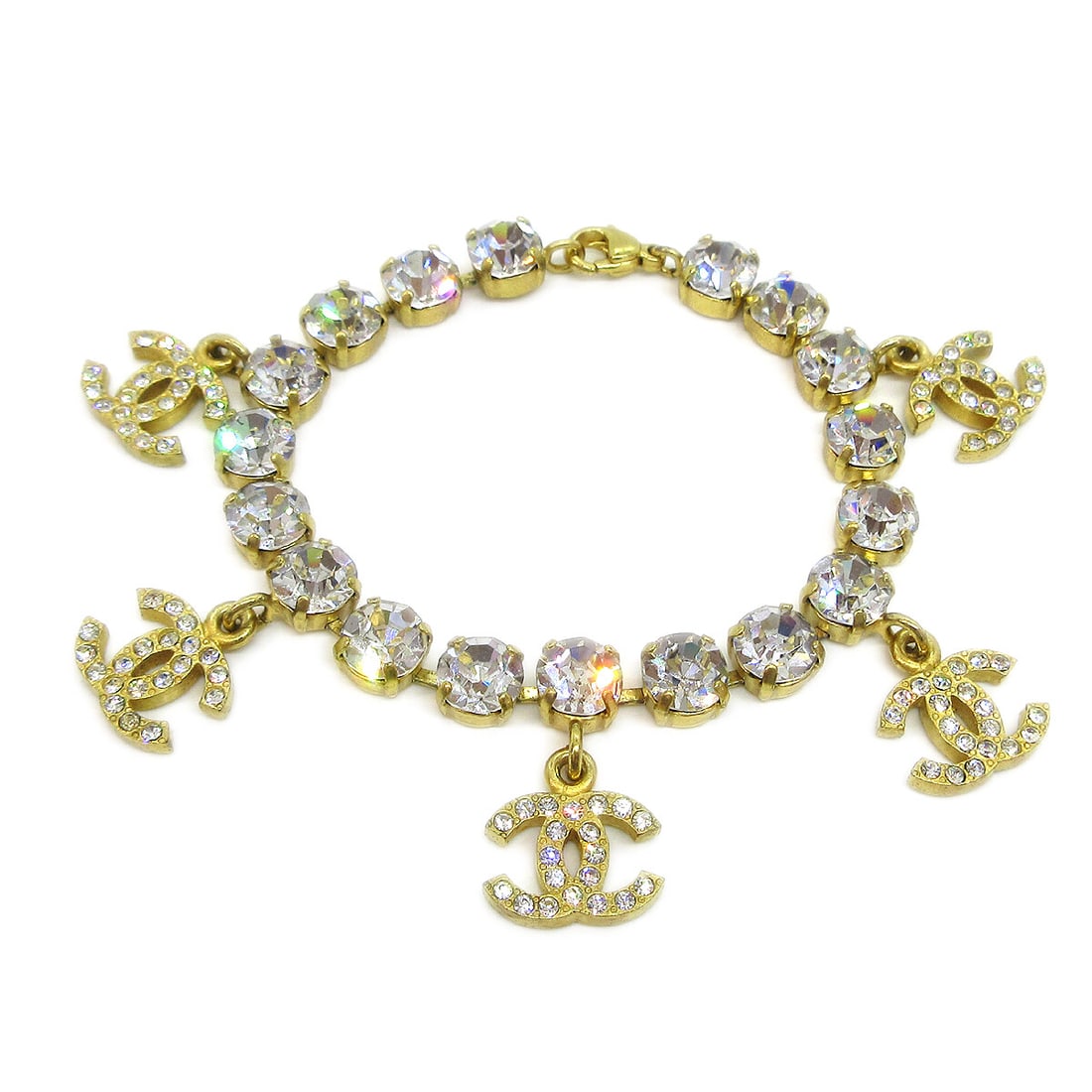 Chanel 95A CC Logo Chain Bracelet Gold Tone Rhinestone: Chanel 95A CC Logo Chain Bracelet Gold Tone Rhinestone Chanel chain link bracelet featuring CC logo charms and clear rhinestone accents in a gold-tone finish. Made in France, this bracelet has a hook-