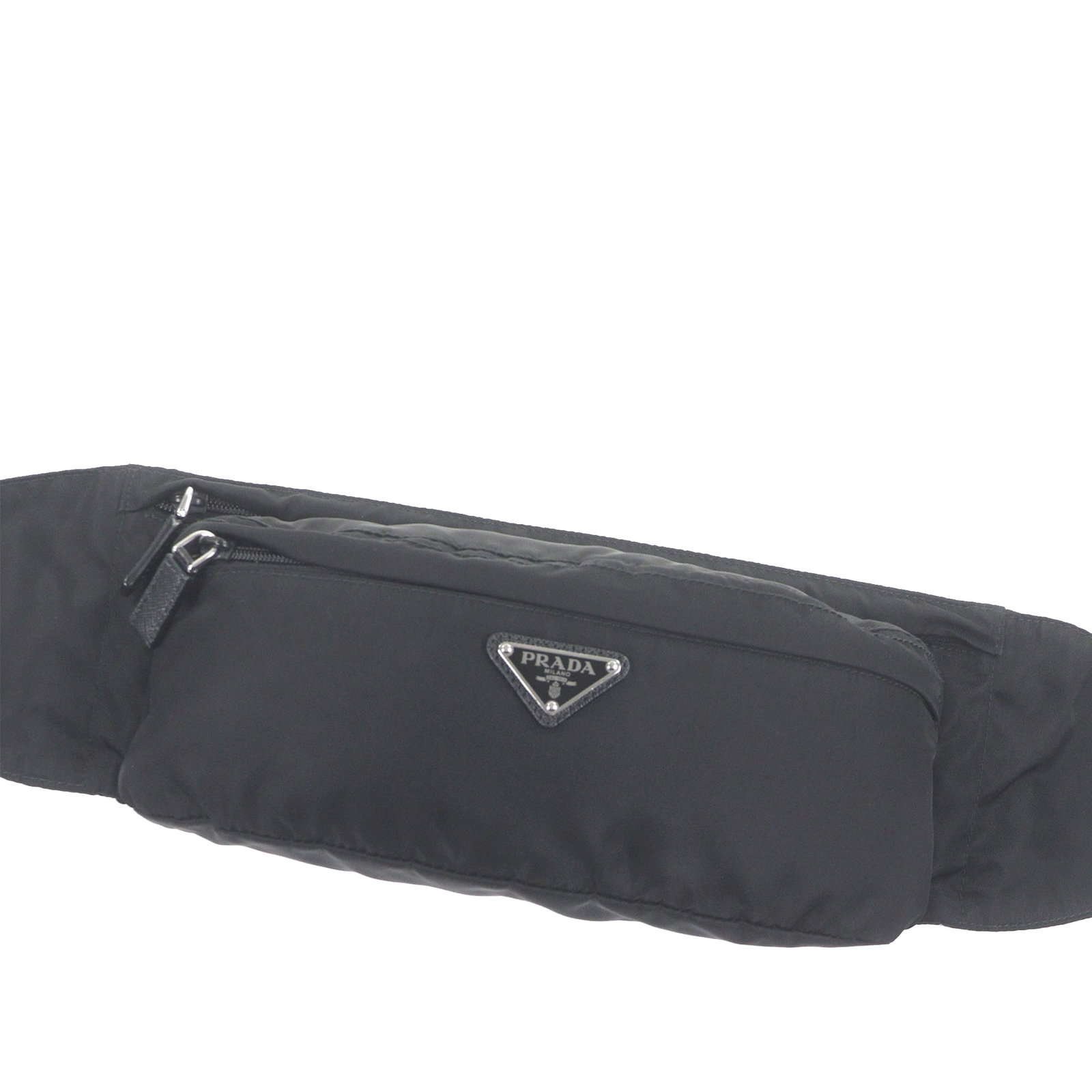Prada Tessuto nylon waist bag in black: Prada Tessuto nylon waist bag in black A Prada Tessuto belt bag crafted with a nylon body and an adjustable flat waist strap. The design includes an exterior front zip pocket and a top zip closure. Ma