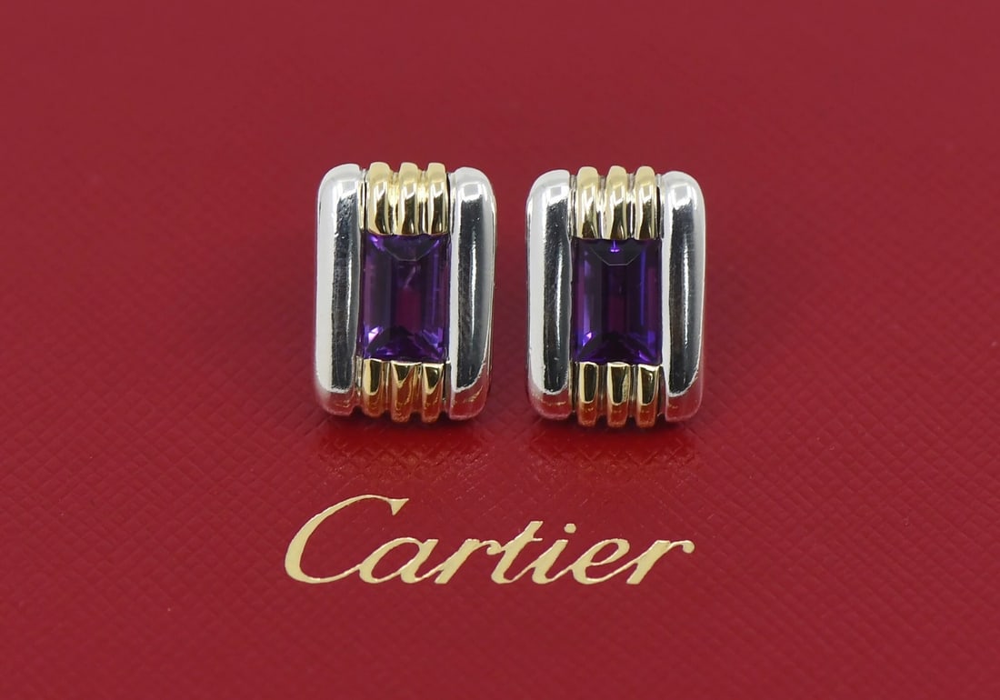 Cartier stud earrings in 18K and sterling silver with amethyst: Cartier stud earrings in 18K and sterling silver with amethyst Pre-owned Cartier amethyst stud earrings crafted in sterling silver and 18K gold. Designed for pierced lobe wear, this signed pair featur