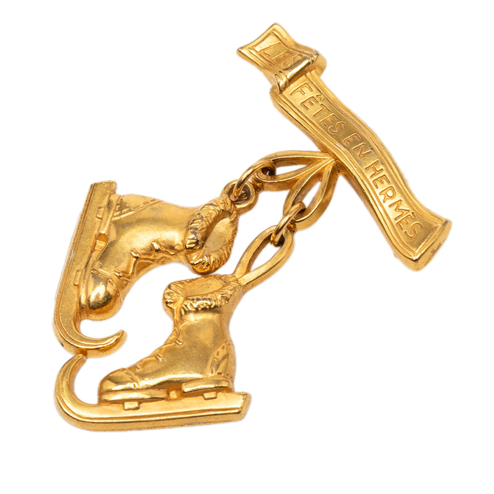 Hermes Les Fetes en Hermes Gold Plated Brooch Pin: Hermes Les Fetes en Hermes Gold Plated Brooch Pin Hermes Les Fetes en Hermes pin brooch crafted in gold-plated metal with a back pin closure. Made in France, this costume jewelry piece includes the bo
