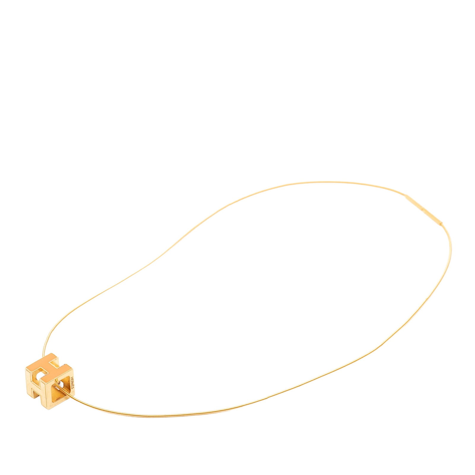 Hermes Cage d H gold plated pendant necklace: Hermes Cage d H gold plated pendant necklace This Hermes Cage d'H Cube necklace features a gold plated metal body with a lacquered pendant and a screw closure. The necklace is crafted in France and de