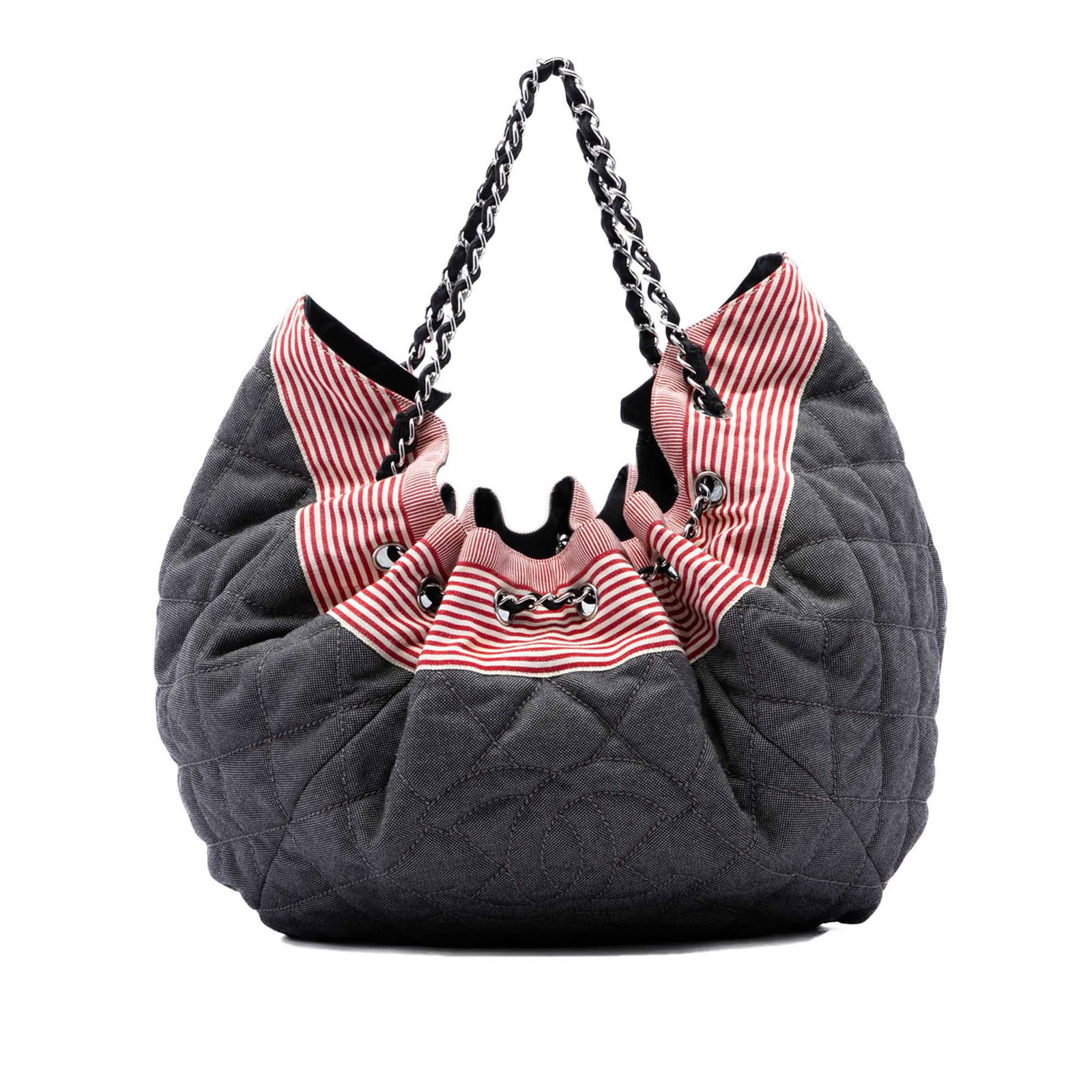 Chanel Stretch Spirit Cabas Large Quilted Denim Tote Bag: Chanel Stretch Spirit Cabas Large Quilted Denim Tote Bag A Chanel tote crafted in blue quilted denim with fabric-woven chain straps and a top drawstring closure. The interior includes a zip pocket for