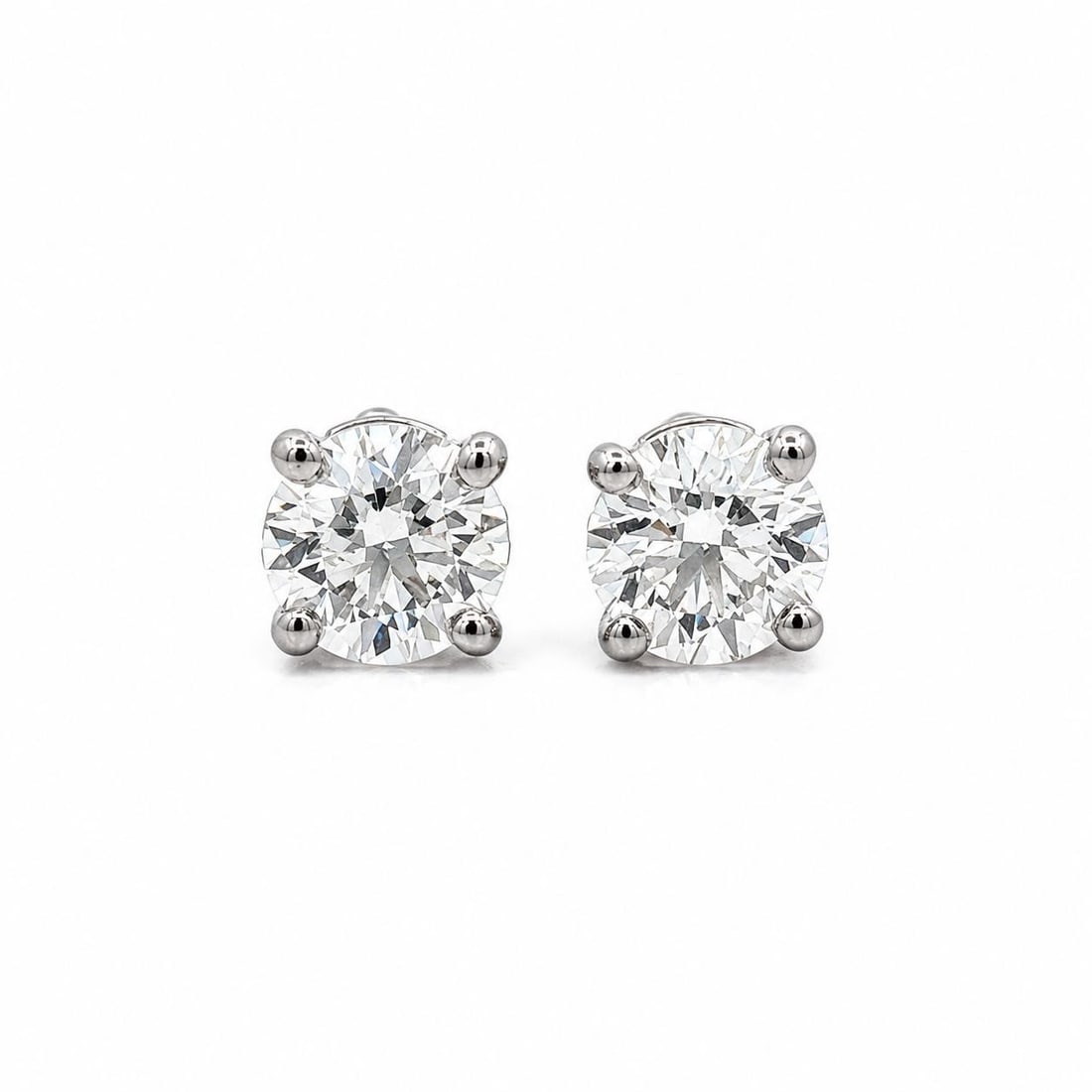 Tiffany & Co. Classic Platinum Diamond Stud Earrings 0.76ctw with Pouch: Tiffany & Co. Classic Platinum Diamond Stud Earrings 0.76ctw with Pouch Classic Tiffany & Co. stud earrings crafted in platinum and set with two natural round brilliant cut diamonds. This pre-owned pa