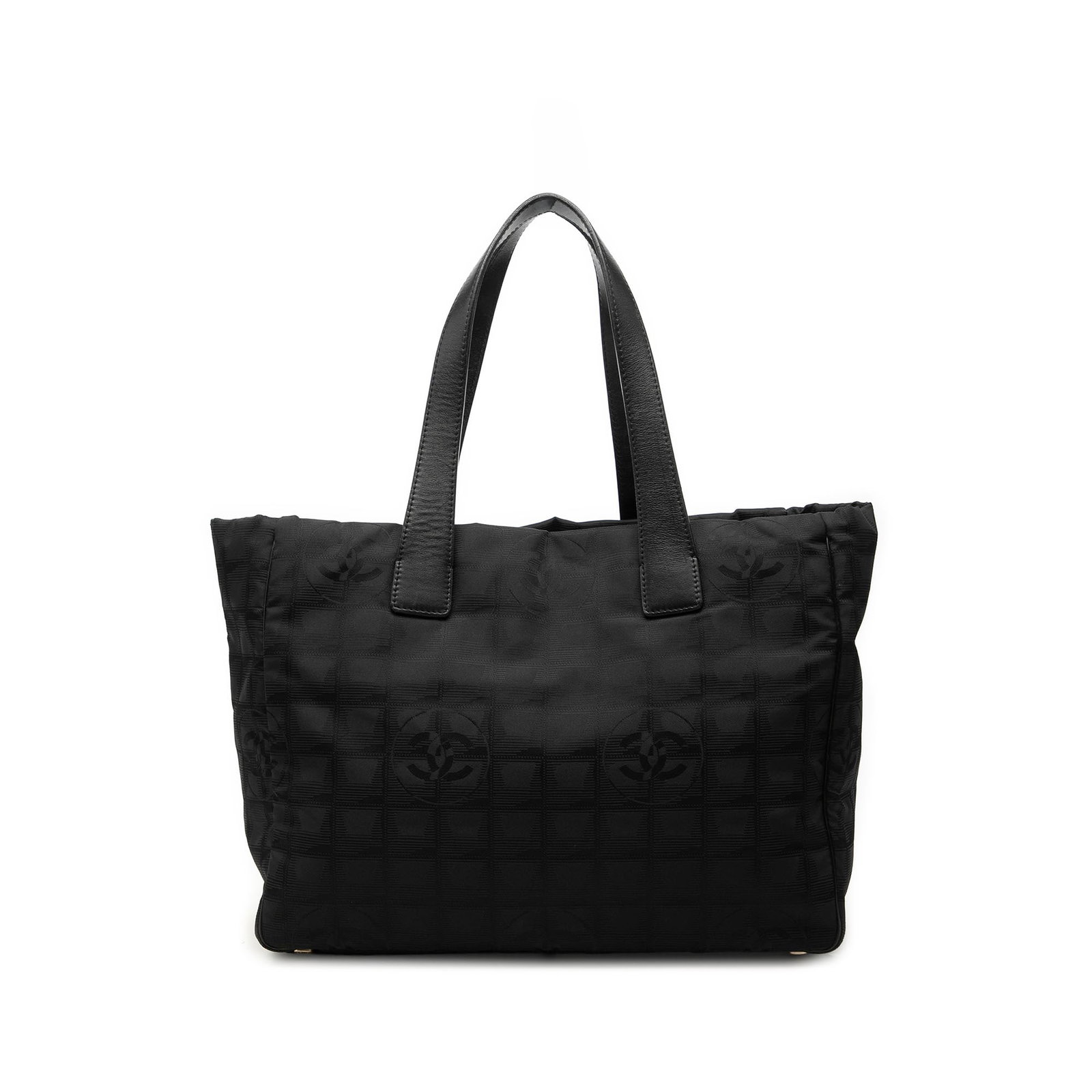 Chanel New Travel Line black nylon tote bag: Chanel New Travel Line black nylon tote bag Chanel New Travel Line tote crafted with a nylon body and leather trim. It features flat leather straps, an open top, and interior zip pockets. Finished in 