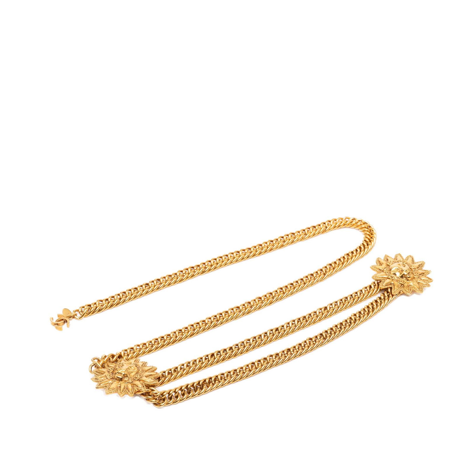 Chanel double lion sunburst CC gold tone chain belt: Chanel double lion sunburst CC gold tone chain belt Chanel chain link belt with a CC motif, double lion, and sunburst design in gold-tone metal. It features a hook closure and shows scratched wear not