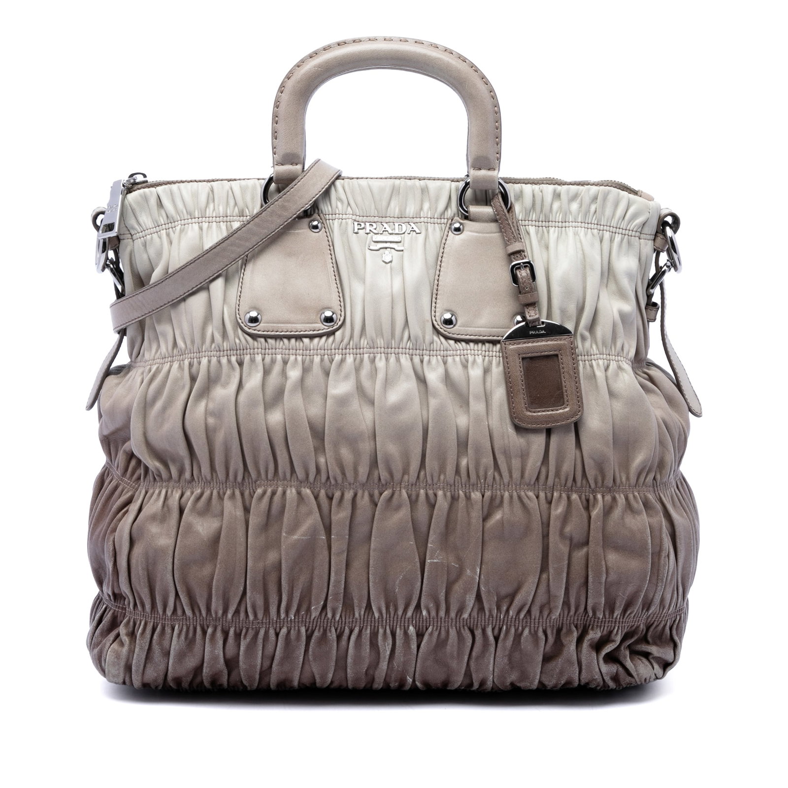 Prada Ombre Gathered Leather Satchel with Detachable Strap: Prada Ombre Gathered Leather Satchel with Detachable Strap Prada Nappa Gaufre Ombre Satchel in beige leather with a gathered body, structured leather handles, and a detachable flat leather strap. The 