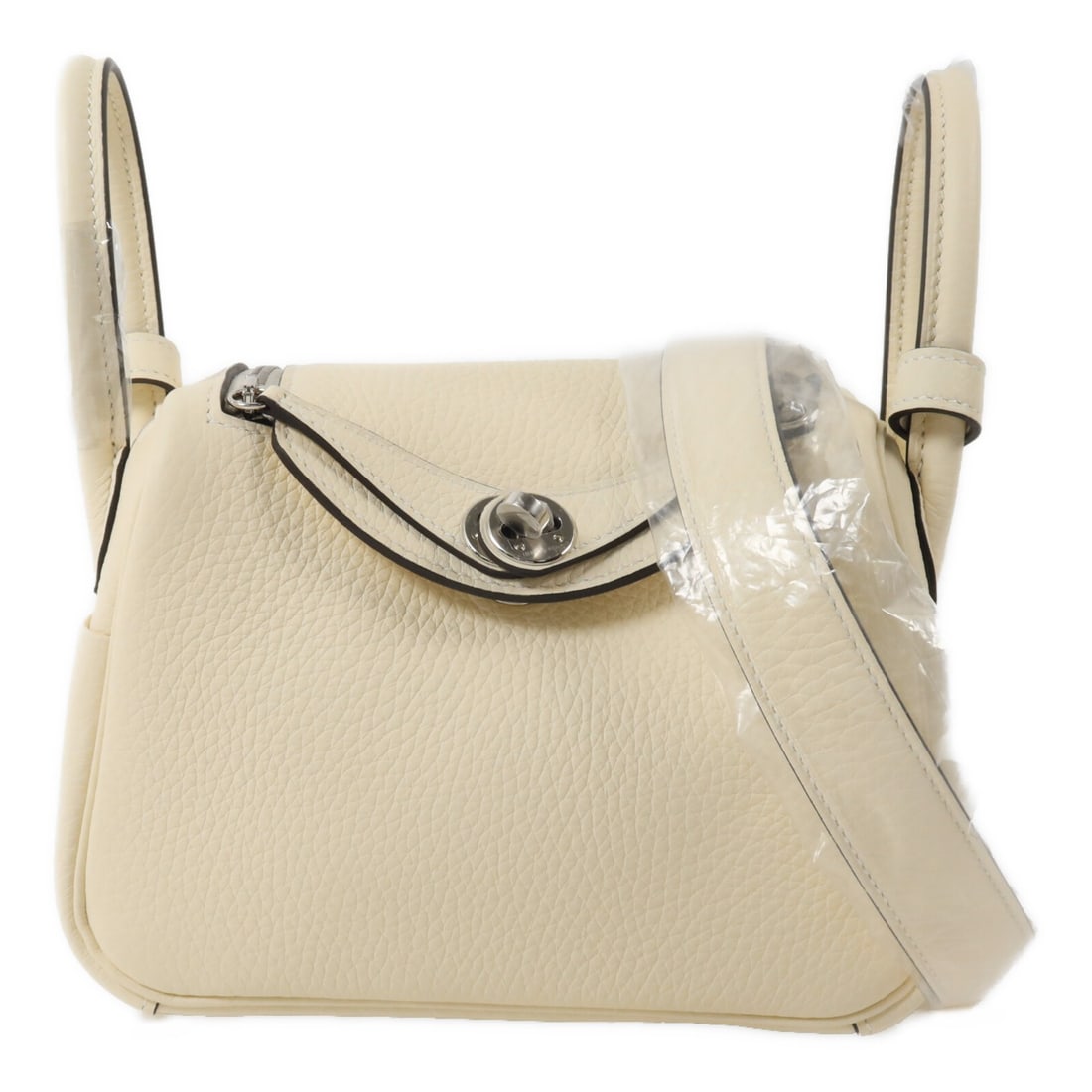 Hermes Mini Lindy 2 Way Shoulder Bag Taurillon Clemence White Cream: Hermes Mini Lindy 2 Way Shoulder Bag Taurillon Clemence White Cream Hermes Mini Lindy 2-way shoulder bag in Taurillon Clemence and calfskin with a white and cream color combination. This women's bag f