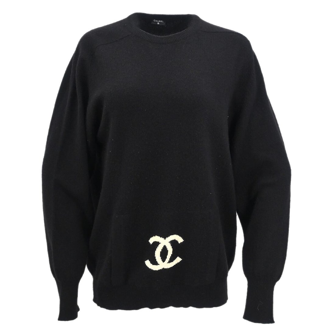 Vintage CHANEL Black Knit Long Sleeve Logo Top: Vintage CHANEL Black Knit Long Sleeve Logo Top Vintage Chanel long sleeve knit top in black with a round neckline, regular fit, and logo accent. This women's casual sweater has one exterior pocket. Co