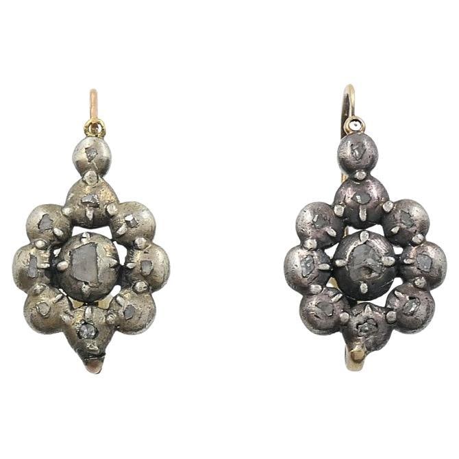 Georgian rose cut diamond floral cluster earrings in silver and 14k gold: Georgian rose cut diamond floral cluster earrings in silver and 14k gold Georgian-era floral cluster earrings featuring patinated silver clusters set with rustic rose cut diamonds in closed-back colle