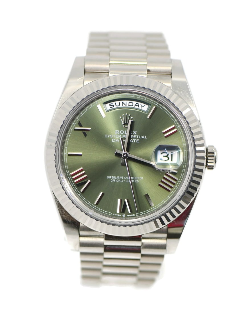 Rolex 228239 Day-Date 40 wristwatch in 18K white gold olive dial: Rolex 228239 Day-Date 40 wristwatch in 18K white gold olive dial Pre-owned Rolex Day-Date wristwatch with an olive green dial, Roman numeral hour markers, and a fluted bezel. This automatic watch is c