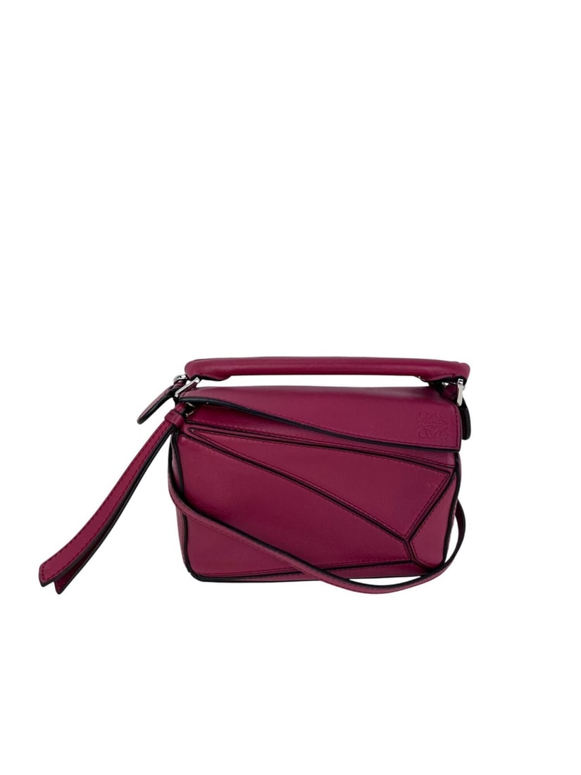 Loewe Puzzle Mini Crossbody Bag in Red Calfskin with Dust Bag: Loewe Puzzle Mini Crossbody Bag in Red Calfskin with Dust Bag This Loewe Mini Puzzle Crossbody Hand Bag is crafted from crimson calfskin leather with a matte finish. It features a rectangular shape, a