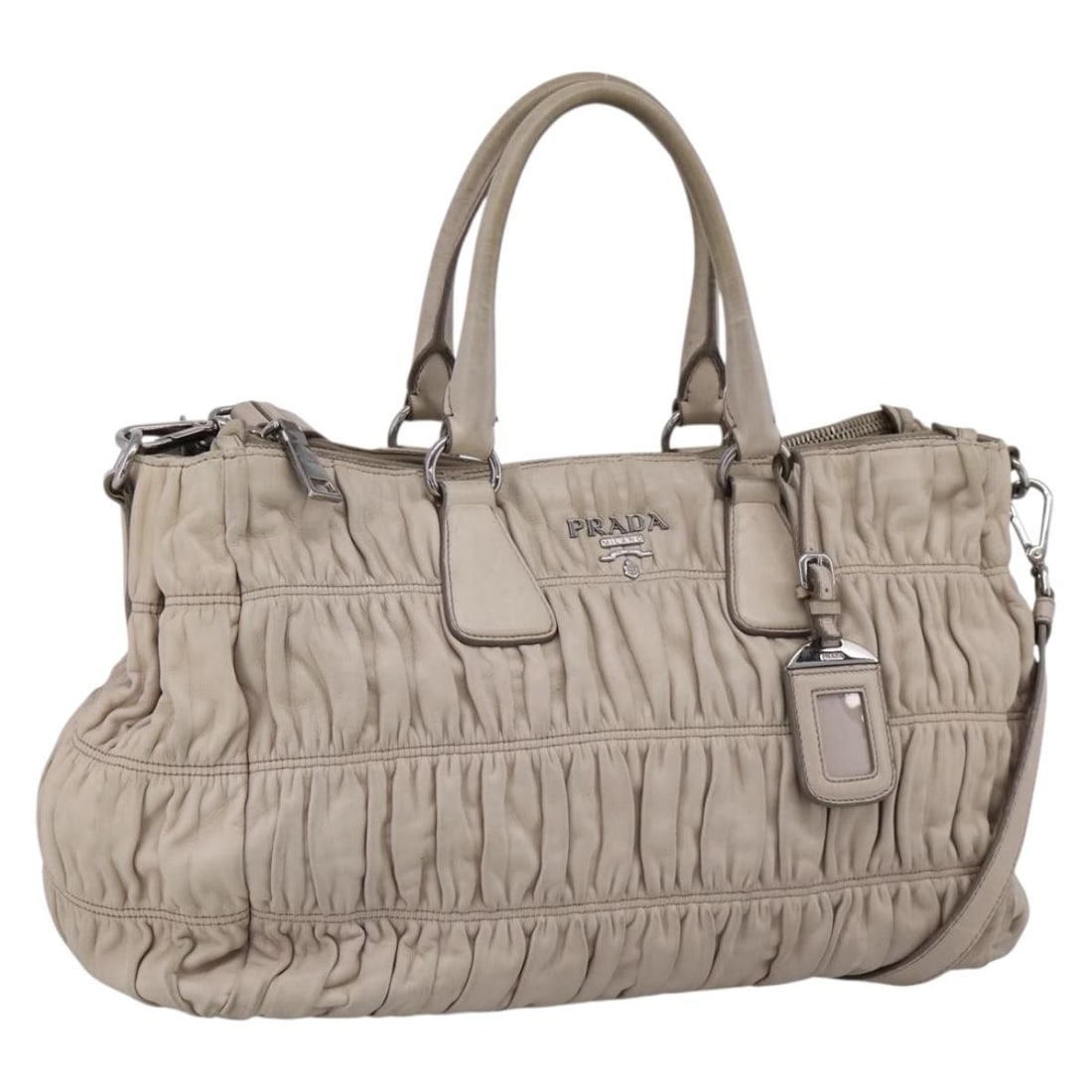 PRADA Ivory Leather 2 Way Handbag with Shoulder Strap: PRADA Ivory Leather 2 Way Handbag with Shoulder Strap Prada gathered 2-way handbag in ivory and silver leather with dual carry options. Includes a name tag and shoulder strap. Made in Italy. Condition