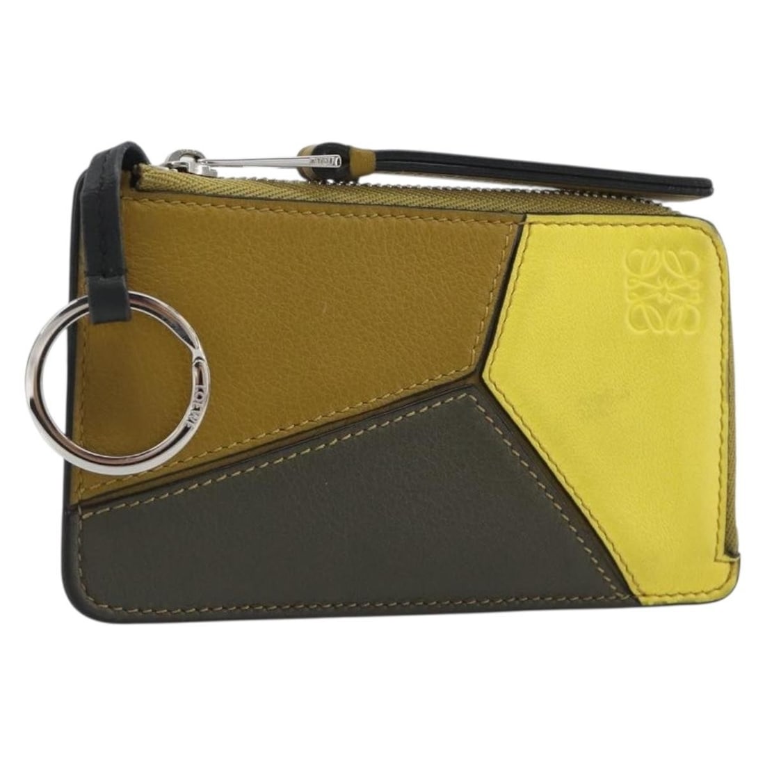 LOEWE leather card case in brown with silver tone box: LOEWE leather card case in brown with silver tone box LOEWE Puzzle card case in brown leather with silver-tone accents. Made in Spain, this women's card case includes the item box. It shows heavy sign