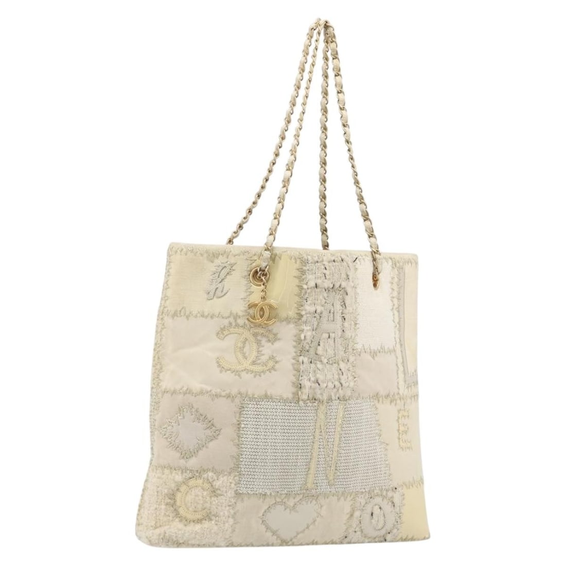 CHANEL Ivory Gold Canvas Tote with Chain Handles and Dust Bag: CHANEL Ivory Gold Canvas Tote with Chain Handles and Dust Bag Chanel patchwork chain tote bag in ivory and gold canvas with CC detailing. Includes a dust bag. Made in France. Condition is AB / very go