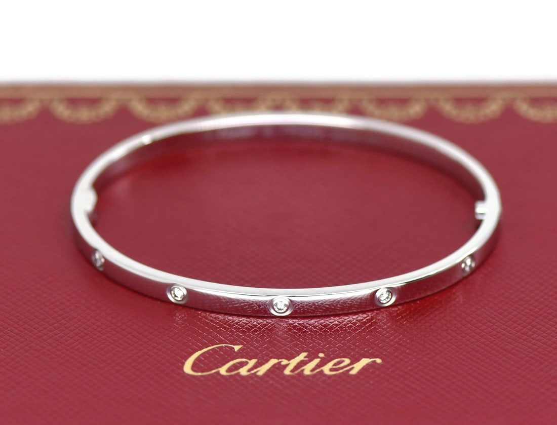 Cartier Love Small Model Bracelet 18K White Gold 10 Diamond Size 16: Cartier Love Small Model Bracelet 18K White Gold 10 Diamond Size 16 Pre-owned Cartier Love bracelet in 18k white gold with 10 diamonds in the small model design. This bangle-style bracelet comes with 