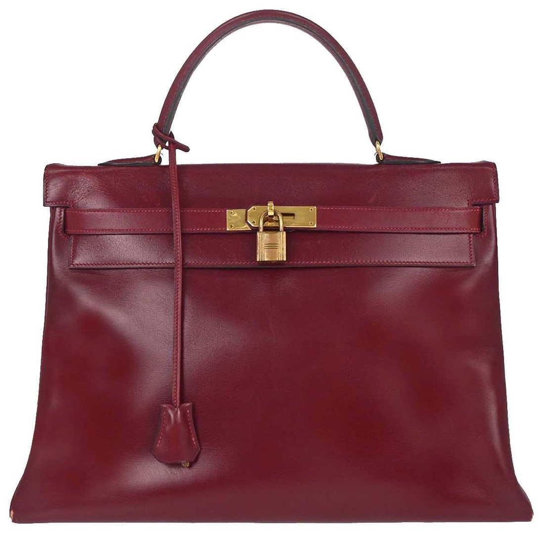 Hermes Kelly 35 Bordeaux Leather Top Handle Bag: Hermes Kelly 35 Bordeaux Leather Top Handle Bag Hermes Kelly 35 Retourne handbag in bordeaux box calf leather with a structured top handle silhouette and turn-lock closure. Made in France, this women'
