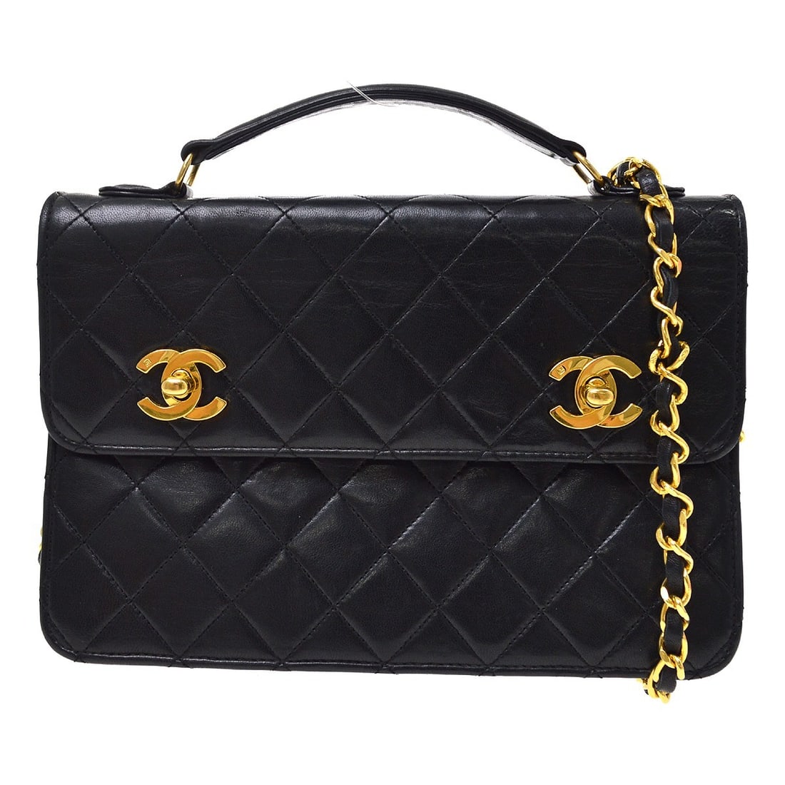 CHANEL CC Medium Top Handle Bag in Black Lambskin: CHANEL CC Medium Top Handle Bag in Black Lambskin Chanel black lambskin 2-way handbag with a double turnlock design and top handle styling. This medium bag features a leather lining, logo accents, a n