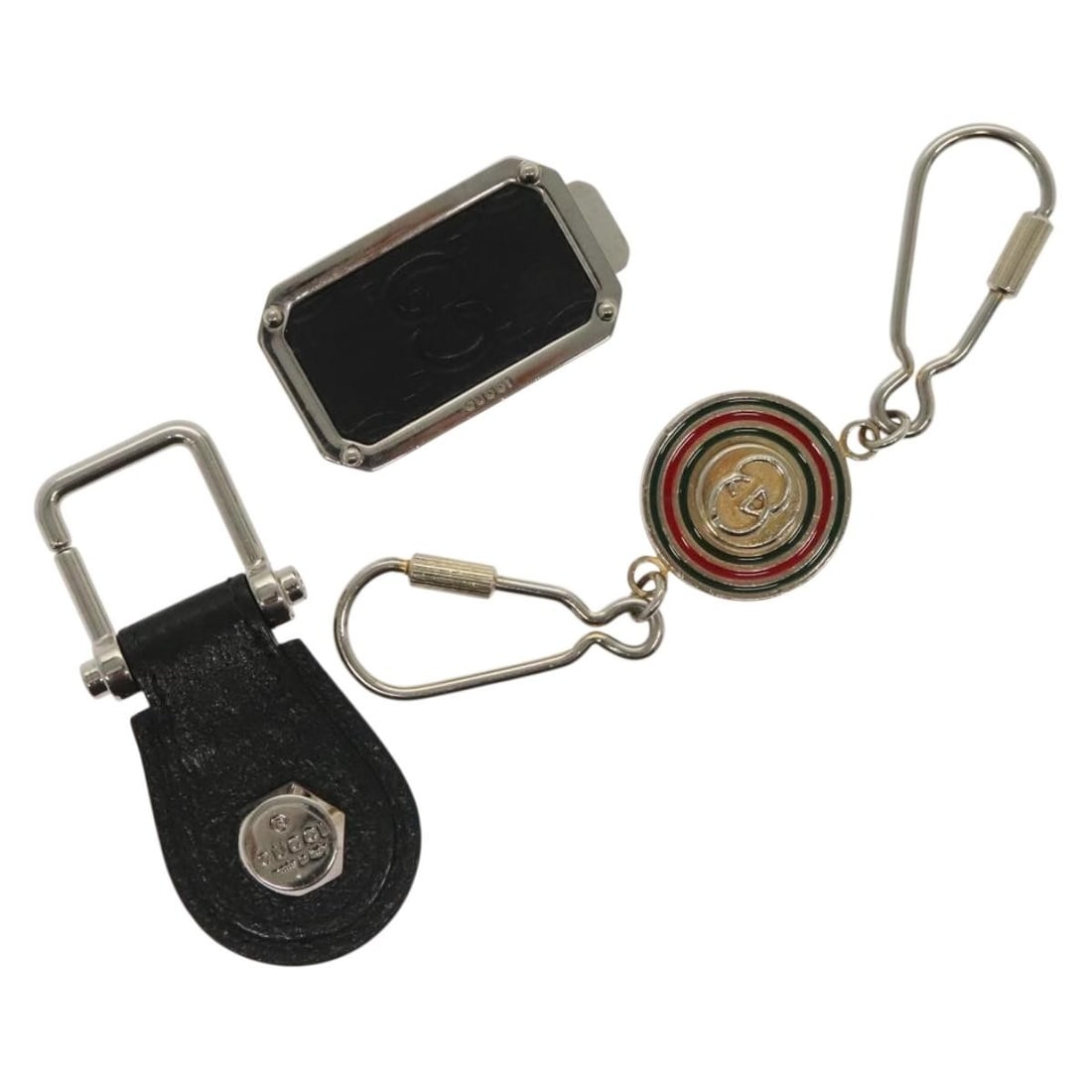 Set of 3 Gucci metal charms in black and silver: Set of 3 Gucci metal charms in black and silver This GUCCI charm set features three exquisite pieces crafted from durable metal in a striking black and silver color scheme. Made in Italy, these charms