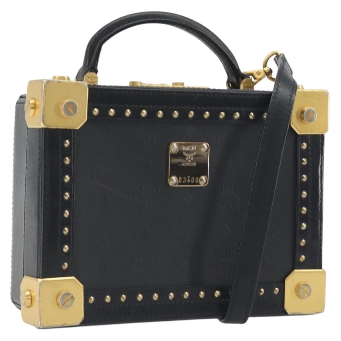 MCM mini trunk bag in black PVC leather with shoulder strap: MCM mini trunk bag in black PVC leather with shoulder strap Authentic MCM Vicetos Logogram mini trunk bag in black and gold PVC leather with a structured 2-way design. This women's bag includes a shou