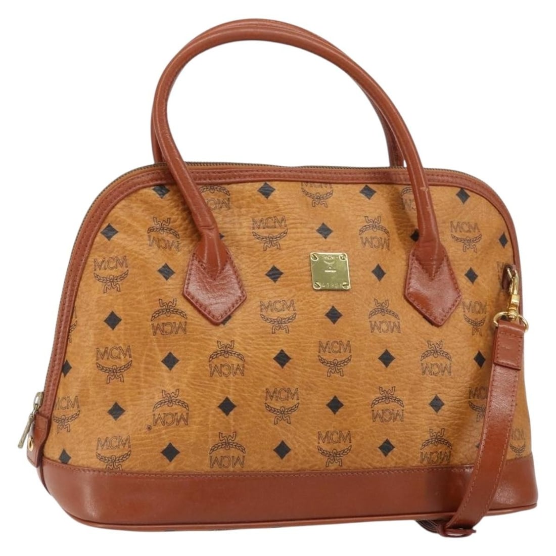 Brown MCM Vicetos Logogram Two Way PVC Leather Handbag with Strap: Brown MCM Vicetos Logogram Two Way PVC Leather Handbag with Strap This MCM Vicetos Logogram hand bag is crafted from PVC leather in brown and gold tones and features a versatile 2-way design. It comes